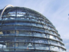 Glaskuppel des Reichstags in Berlin vor blauem, leicht bewölktem Himmel. Rechts oben Logo von ANGA Der Breitbandverband